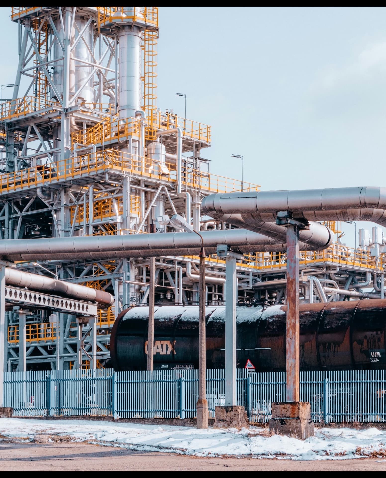 Network of insulated process piping running through a refinery unit
